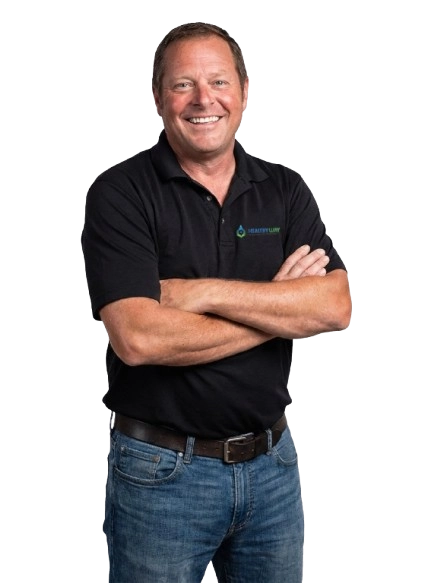 Smiling man in a black Healthy Way polo shirt, showcasing expertise in mold remediation and waterproofing services for homes and offices in New Jersey.