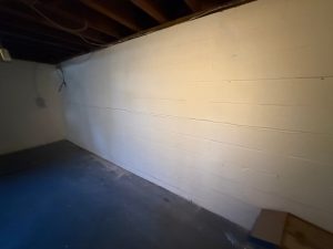 Basement wall showing potential foundation issues, emphasizing the need for structural repair solutions and carbon fiber reinforcement methods.